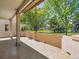 Covered back patio with tile flooring and a low wall, ideal for outdoor relaxation at 946 Champion Cir, Longmont, CO 80503