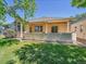 Lush backyard with a well-manicured lawn, patio area, and mature trees, perfect for outdoor relaxation at 946 Champion Cir, Longmont, CO 80503