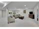 Large open basement with a sitting area, a decorative mirror, and a cabinet for an entertainment center at 946 Champion Cir, Longmont, CO 80503