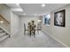 Cozy basement area with a small table and four chairs next to a window and stairs at 946 Champion Cir, Longmont, CO 80503