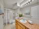Bright, clean bathroom with a neutral color palate is well-lit by lights above the large mirror at 946 Champion Cir, Longmont, CO 80503