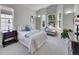 Comfortable bedroom features a sitting area in front of a trio of windows that bring light into the room at 946 Champion Cir, Longmont, CO 80503