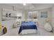Cozy bedroom featuring a plush blue quilt, neutral walls, and bright natural light at 946 Champion Cir, Longmont, CO 80503