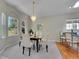Elegant dining room featuring a chandelier and large windows at 946 Champion Cir, Longmont, CO 80503