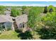 Beautiful exterior with lush greenery, mature trees, and well maintained lawn at 946 Champion Cir, Longmont, CO 80503