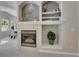 Elegant fireplace with decorative shelving, adjacent to the dining area at 946 Champion Cir, Longmont, CO 80503