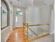 Inviting foyer with hardwood floors, staircase with white railings, and a view of the front door at 946 Champion Cir, Longmont, CO 80503