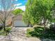 Charming home featuring a well-manicured lawn, mature trees, and a two-car garage at 946 Champion Cir, Longmont, CO 80503