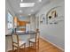 Bright kitchen featuring a breakfast bar with stylish stools, hardwood floors, and decorative wall niches at 946 Champion Cir, Longmont, CO 80503
