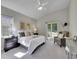 Vaulted ceiling main bedroom with a sitting area, large window, and neutral carpeting at 946 Champion Cir, Longmont, CO 80503