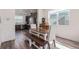 Stylish dining area featuring a wooden table, bench seating, and stainless steel appliances at 2080 Alcott Way, Broomfield, CO 80023