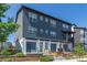 Contemporary townhouse with gray siding, white trim, a small porch, and a well-maintained front yard at 2080 Alcott Way, Broomfield, CO 80023