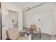 Flex room with chairs, small table, and view through an open door to a powder bath at 2080 Alcott Way, Broomfield, CO 80023
