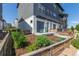 Modern townhouse with a fenced front yard and garden featuring green rocking chairs and a patio at 2080 Alcott Way, Broomfield, CO 80023