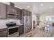 Open-concept kitchen with stainless steel appliances and ample cabinet space adjacent to a dining area at 2080 Alcott Way, Broomfield, CO 80023