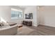 Cozy living room featuring hardwood floors, a sectional sofa, and a flat screen TV at 2080 Alcott Way, Broomfield, CO 80023
