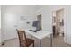 Bright office with a modern desk, neutral carpet, and a view to a full bath through the open door at 2080 Alcott Way, Broomfield, CO 80023
