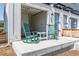 Front patio with rocking chairs, a small table, and a view into the garage at 2080 Alcott Way, Broomfield, CO 80023