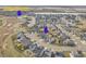 Aerial view of neighborhood with community pool and clubhouse overlooking a scenic lake at 4884 St Vrain Rd, Firestone, CO 80504