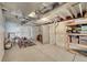 Unfinished basement with white plastic wall coverings, exposed ductwork, and space for storage and recreation at 4884 St Vrain Rd, Firestone, CO 80504