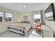 Inviting bedroom with a colorful quilt, large windows, and an orange chair, offering a comfortable retreat at 4884 St Vrain Rd, Firestone, CO 80504