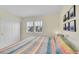 Bright bedroom with a colorful quilt, closet, and natural light, providing a cozy and functional area at 4884 St Vrain Rd, Firestone, CO 80504