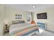 Charming bedroom featuring a colorful quilt, modern furniture, and a wall-mounted TV, creating a relaxing space at 4884 St Vrain Rd, Firestone, CO 80504