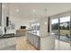 Eat-in kitchen featuring stainless steel appliances and views of the backyard and adjacent living space at 4884 St Vrain Rd, Firestone, CO 80504