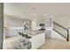 Modern eat-in kitchen with gray cabinets, granite countertops, stainless steel appliances, and a large island at 4884 St Vrain Rd, Firestone, CO 80504