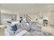 Open-concept living room featuring a large sectional sofa and easy access to the kitchen and dining area at 4884 St Vrain Rd, Firestone, CO 80504