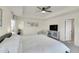 Bright main bedroom featuring a ceiling fan, sitting area, and ensuite bathroom access at 4884 St Vrain Rd, Firestone, CO 80504