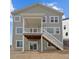 Exterior view of home with a deck and stair access to the yard at 1136 Hillside Ln, Louisville, CO 80027