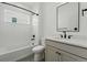 Modern bathroom with white subway tile, black fixtures and gray tile floors at 1136 Hillside Ln, Louisville, CO 80027