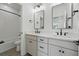 Modern bathroom featuring dual sinks, large mirrors, and sleek black fixtures at 1136 Hillside Ln, Louisville, CO 80027