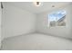 Minimalist bedroom with plush carpet and a large window offering natural light at 1136 Hillside Ln, Louisville, CO 80027