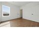 Bright, spacious bedroom with hardwood floors and scenic views from the large window at 1136 Hillside Ln, Louisville, CO 80027