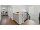 Hallway features modern cabinets and staircase with black metal railing at 1136 Hillside Ln, Louisville, CO 80027