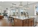 Open-concept kitchen featuring an island with a sink, stainless steel appliances, and seamless view to living area at 1136 Hillside Ln, Louisville, CO 80027
