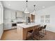 Bright kitchen features a large island with seating, modern appliances, and stylish pendant lighting at 1136 Hillside Ln, Louisville, CO 80027