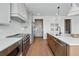 Modern kitchen features stainless steel appliances, light countertops, and a large island with seating at 1136 Hillside Ln, Louisville, CO 80027