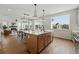 Modern kitchen featuring an island with a sink, stainless steel appliances, and seamless view to living area at 1136 Hillside Ln, Louisville, CO 80027