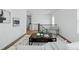 Bright living room with neutral decor, a patterned rug, and modern staircase at 1136 Hillside Ln, Louisville, CO 80027