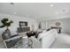 Bright living room featuring modern decor, plush seating, and game table at 1136 Hillside Ln, Louisville, CO 80027