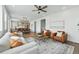 Open-concept living room with modern furniture, a seamless view to the kitchen and hardwood floors at 1136 Hillside Ln, Louisville, CO 80027