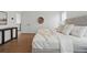 Inviting bedroom showcases a luxurious bed, a hardwood floor, and soothing, neutral decor at 1136 Hillside Ln, Louisville, CO 80027