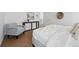 Inviting bedroom showcases a luxurious bed, a hardwood floor, and soothing, neutral decor at 1136 Hillside Ln, Louisville, CO 80027