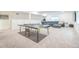 Finished basement features a ping pong table, leather sectional, and carpet floors at 6311 Stable View St, Castle Pines, CO 80108