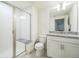 Bright bathroom features a glass shower with seat, granite countertop, and modern white vanity at 6311 Stable View St, Castle Pines, CO 80108