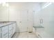 Bright bathroom features a glass shower with seat, granite countertop, and modern white vanity at 6311 Stable View St, Castle Pines, CO 80108
