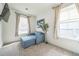 Relaxing bedroom with a blue chair and ottoman, soft lighting, and neutral decor, providing a tranquil retreat at 6311 Stable View St, Castle Pines, CO 80108